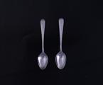 A pretty pair of Victorian Old English bright cut pattern sterling silver teaspoons