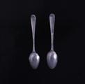 A pretty pair of Victorian Old English bright cut pattern sterling silver teaspoons