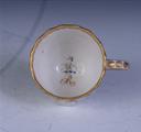 A Derby armorial porcelain coffee cup and saucer