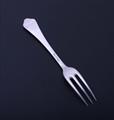 A sterling silver three pronged fork