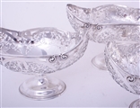 An impressive set of three Edwardian sterling silver fruit baskets