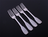 A matched set of four 18th century French provincial fiddle pattern armorial silver table forks