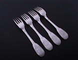 A matched set of four 18th century French provincial fiddle pattern armorial silver table forks