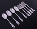 A set of eight Scottish Edwardian Old English pattern sterling silver dessert spoons and forks