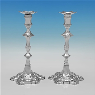 Pair of cast silver candlesticks